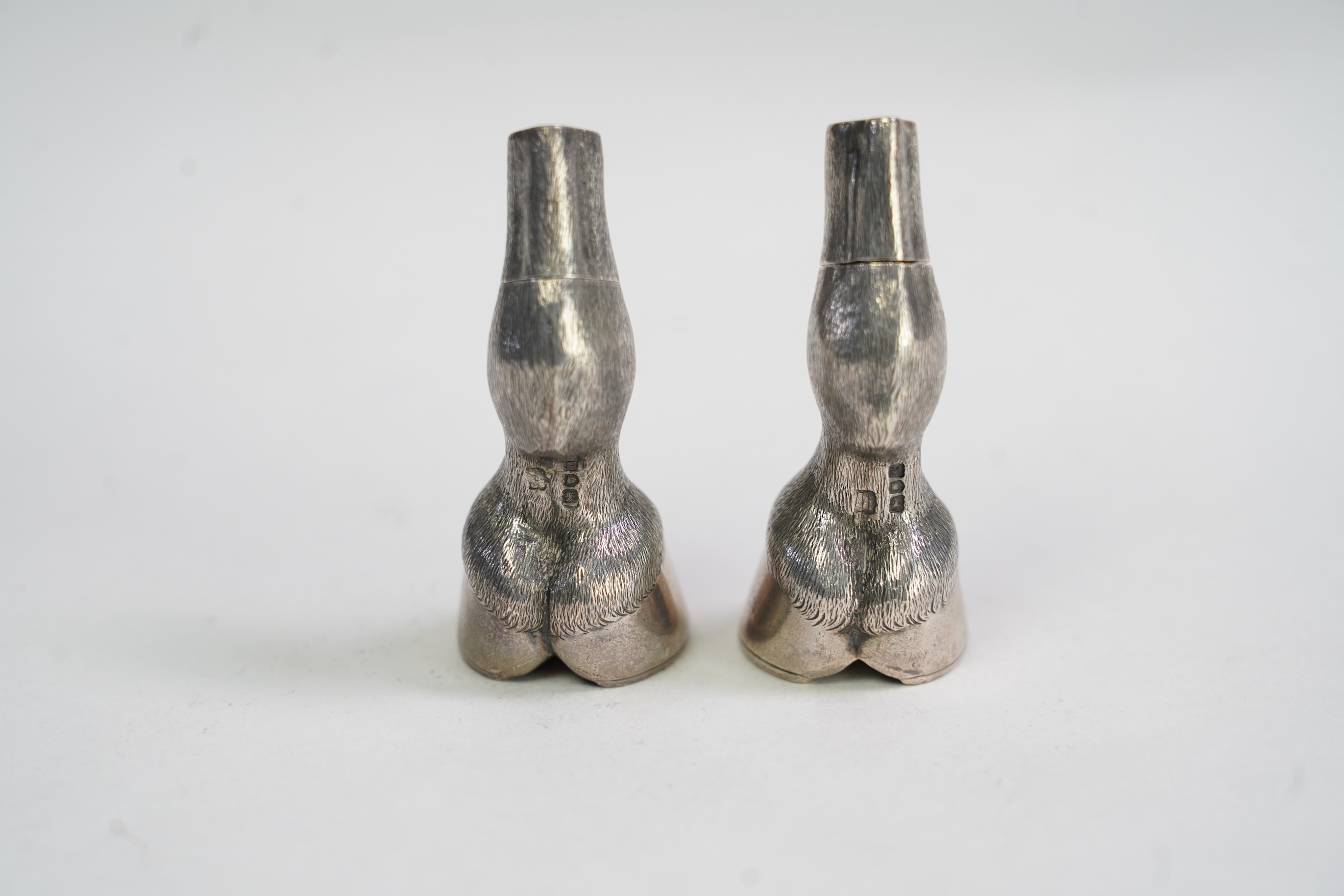 A pair of Edwardian novelty silver condiments modelled and a horse's fetlock and hoof, makers mark rubbed